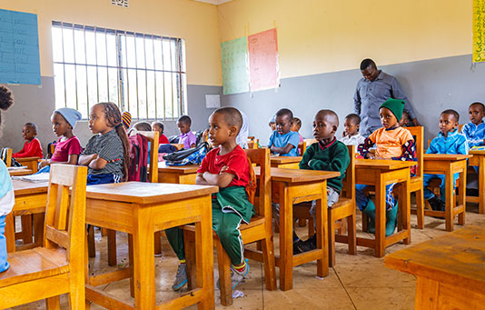 Students at New Hope School in Arusha, Tanzania sit at their desks.